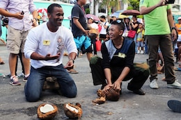 U.S. Navy Petty Officer 2nd Class Carl Watson, left, breaks open a coconut April 24 during the Kudkod-Paga, Turo-Gata contest at the Magayan Festival alongside Philippine Army Pfc. Bryldon Alforte in Legazpi City, Albay Province, Philippines. Kudkod-Paga, Turo-Gata means “coconut milk extraction contest,” and is a contest during the annual festival to determine who can produce the most milk in a given time. Watson and Alforte are part of Exercise Baltikatan, an annual bilateral exercise between the Armed Forces of the Philippines and United States armed forces that strengthens the bond and improves interoperability between the two countries. Alforte is an operations noncommissioned officer, and Watson is a naval builder.