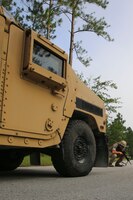 Marine Cpl. Adam Dwaileibe, Motor-transport Operator, Combat Logistics Battalion 2, 2nd Marine Logistics Group and Cincinnati, Ohio native, looks  underneath a humvee during a five and 25 meter scan as part of the practical application portion of a counter-IED class August 20, 2014 in Holly Ridge, North Carolina.  Instructors taught Marines to perform the five and 25 meter scan to avoid stopping near the kill zone of an IED.  During the scan, Dwailebe looked for abnormalities and secondary IED's.  The purpose of the training was to keep the Marines ready to employn a counter-IED skill-set.
