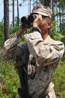 Lance Cpl. Lorenzo Knowles, Landing Support, Combat Logistics Battalion 2, 2nd Marine Logistics Group and Jacksonville, Florida native looks through a pair of binoculars in search of IED indicators during a counter-IED training course August 19, 2014 in Holly Ridge, North Carolina.  Counter-IED instructors taught the Marines to search for indicators by scanning right to left and down to up, in order to trick your brain into paying better attention to your surroundings.  Marines were also taught immediate actions to take once an IED is spotted.