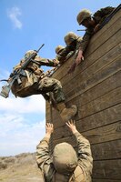 Recruits of Mike Company, 3rd Recruit Training Battalion, assist a fellow recruit climb a wall during Gonzalez’s Challenge at Marine Corps Base Camp Pendleton, Calif., Aug. 20. Gonzalez’s Challenge, is a two part exercise designed to promote teamwork. 