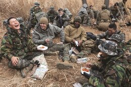 U.S. Marines enjoy a quick lunch with Republic of Korea Marines Feb. 6 during Korean Marine Exchange Program 14-3 near Pohang, Republic of Korea. As the Marines ate, they exchanged food and shared laughs. “The ROK Marines are awesome,” said Sgt. Robert L. Ponder, an intelligence analyst with the 3rd Reconnaissance Battalion. “Eating with them and talking with them definitely helps strengthen ties and deepen the relationship; because of this I got to meet a lot more of the ROK Marines and this definitely helps motivate me for the hike because now they aren’t just people I’m hiking with, they are Marines I’m enduring with.”