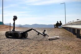 Marines with 1st Explosive Ordnance Disposal Company, 7th Engineer Support Battalion, observe as the TALON Mark II robot attempts to pick up a block during pre-deployment training aboard Camp Pendleton, Calif., Feb, 18, 2014. The Marines with 1st EOD have been training since September of last year in preparation for their upcoming deployment to Afghanistan next month in support of Operation Enduring Freedom.