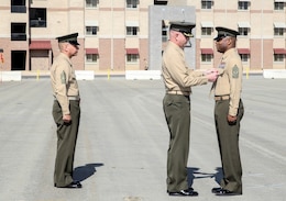 Lieutenant Col. John O’Neal, center, commanding officer, 15th Marine Expeditionary Unit, pins the Legion of Merit Medal on Sgt. Maj. John Scott, right, during a relief and appointment ceremony aboard Camp Pendleton, Calif., Feb. 21, 2014. Scott will be taking charge as the senior enlisted advisor to Marine Corps Forces Special Operations Command, Camp Lejeune, N.C. (U.S. Marine Corps photo by Cpl. Emmanuel Ramos/Released)