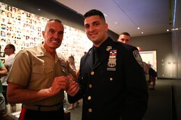 Brigadier Gen. Vincent Coglianese, 1st Marine Logistics Group Commanding General, gives Officer Joseph Maarleveld, of the New York Port Authority Police , his coin during a tour of the 9/11 Museum in New York, June 25, 2014. Brigadier Gen. Coglianese traveled to New York City to officiate Col. James Maxwell’s retirement ceremony. Maxwell, a New York State trooper and Marine, served 32 in the Marine Corps. During his career he served in Operation Desert Shield, Operation Desert Storm and Operation Enduring Freedom.