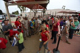 Drew Brees, far left, New Orleans Saints quarterback and former San Diego Charger, signs autographs for service members and families during the NFL Football Star Experience aboard Marine Corps Air Station Miramar, Calif., July 15. The NFL Football Star Experience included various drills performed by NFL players and the Miramar Falcons. 