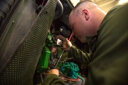Lance Cpl. Gus O’Brien, an engineer equipment electrical systems technician, or generator mechanic, with Combat Logistics Company 11, Combat Logistics Regiment 15, searches for a dropped tool during repairs on a generator aboard Marine Corps Air Station Miramar, Calif., July 22. While deployed, Marines like O’Brien can provide repairs and prolong the use of generators responsible for powering equipment used in operations and missions for several months. 