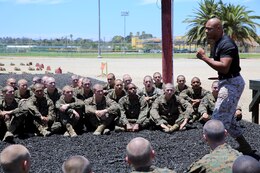 Sgt. Hervacio H. Mata, Marine Corps Martial Arts Program instructor, Support Battalion, shows recruits how to hold a knife correctly during a MCMAP session at Marine Corps Recruit Depot San Diego, July 21. Recruits earn a tan belt in recruit training and can progress when they get to their military occupational specialty school. 