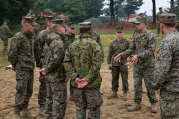 Staff Sgt. Jarret Garibaldi, second from right, instructs a group of Marines on improvised explosive device recognition techniques June 3 on Camp Mujuk, Republic of Korea. Marines with 3rd Law Enforcement Battalion executed IED lane training as a refresher in preparation for the Korean Marine Exchange Program 14-8. KMEP 14-8 is a combined, small-unit training exercise, which enhances the combat readiness and interoperability of ROK-U.S. Marine Corps forces. The Marines are with 3rd LE Bn., III Marine Expeditionary Force Headquarters Group, III Marine Expeditionary Force. Garibaldi is an explosive ordnance disposal technician with 3rd EOD Company, 9th Engineer Support Battalion, 3rd Marine Logistics Group, III MEF. (U.S. Marine Corps photo by Lance Cpl. Drew Tech/Released)