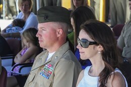 Lieutenant Col. Colin Smith, the commanding officer of 1st Combat Engineer Battalion, 1st Marine Division, and his wife Wendy listen to remarks from Maj. Gen. Lawrence Nicholson, the commanding general of 1st Marine Division, at the 1st CEB change of command ceremony aboard Camp Pendleton, Calif., June 18, 2014. Smith is returning to 1st CEB after serving as the commanding officer of Company C more than a decade ago.