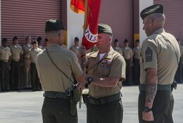 Lieutenant Col. Andrew Winthrop, the former commanding officer of 1st Combat Engineer Battalion, 1st Marine Division, passes the battle colors to Lt. Col. Colin Smith, the commanding officer of 1st CEB, 1st Marine Division, aboard Camp Pendleton, Calif., June 18, 2014. Winthrop served as the 1st CEB commanding officer for 18 months.