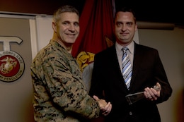 Brig. Gen. John W. Bullard presents Steven Carlen with the Outstanding Housing/Billeting Employee of the Year award March 4.

With his supervisor temporarily assigned to Headquarters Marine Corps, Carlen acted as the fiscal director from October 2013 to January 2014. During this time he ensured efficient utilization of programmed funds, while drafting and submitting all budget reporting information on time with 100% accuracy, according to his award.

Bullard is the commanding general, Marine Corps Installations-West, Marine Corps Base Camp Pendleton. Carlen is the budget analyst for the Family Housing Branch