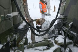 Giskaas, Norway – Sergeant Michael Hall, a platoon leader with Golf Company, 2nd Battalion, 2nd Marine Regiment, 2nd Marine Division and Sharptown, Md., native cuts down a tree that blocked the route of a Bandvagn 206 during a pre-environmental training field exercise to prepare them for exercise Cold Response 2014. Marines and Norwegian soldiers spent three days learning to work together and how to operate in the Norwegian winter environment to prepare the Marines and soldiers for Exercise Cold Response, which is a multinational and multilateral training exercise. The exercise will feature various types of military training including maritime, land and air operations. The location, above the Arctic Circle in northern Norway, provides a unique cold-weather environment for all forces involved to learn and develop procedures from one another.
