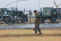 A Marine with Headquarters Battalion, 3d Marine Division, III Marine Expeditionary Force buries a communications wire at the combined operations center at K2 air base in Daegu, South Korea March 12. The 3d Marine Division command post was established in order to support MEFEX 2014. MEFEX 2014 will consist of a Command Post Exercise, a Field Training Exercise, and bilateral live-fire training.


