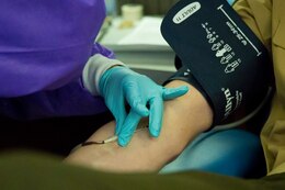 A technician with the Armed Services Blood Program inserts a needle in a Marine’s arm during the 2nd Marine Logistics Group blood drive aboard Marine Corps Base Camp Lejeune, N.C., March 14, 2014. Volunteers donated one pint of blood, which can save up to three lives. 