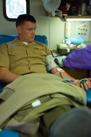 Lance Cpl. David Cline, a Marine with the Landing Support Company, Combat Logistics Regiment 27, 2nd Marine Logistics Group, donates blood in front of the 2nd MLG headquarters building aboard Marine Corps Base Camp Lejeune, N.C., March 14, 2014. More than 90 Marines attended the blood drive to donate a pint of blood. 