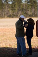 Becky Ruocco, the spouse of Navy Capt. Peter A. Ruocco, the executive officer of 2nd Dental Battalion, 2nd Marine Logistics Group, II Marine Expeditionary Force, receives instructions from a shooting coach at the McIntyre Shooting Complex aboard Camp Lejeune, N.C., March 21, 2014. The battalion hosted the skeet shooting and archery event to help build connections among its service member’s families.  (U.S. Marine Corps photo by Lance Cpl. Shawn Valosin)