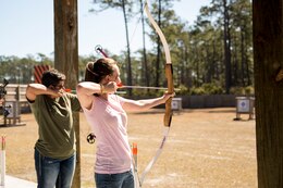 Spouses of sailors with 2nd Dental Battalion, 2nd Marine Logistics Group, II Marine Expeditionary Force shoot archery at the McIntyre Shooting Complex aboard Camp Lejeune, N.C., March 21, 2014. The battalion hosted the skeet shooting and archery event to help build connections among its service member’s families. (U.S. Marine Corps photo by Lance Cpl. Shawn Valosin)