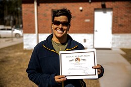 A spouse with 2nd Dental Battalion, 2nd Marine Logistics Group, II Marine Expeditionary Force holds a certificate after participating in a spouse meet and greet at the McIntyre Shooting Complex aboard Camp Lejeune, N.C., March 21, 2014. (U.S. Marine Corps photo by Lance Cpl. Shawn Valosin)