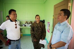 Vittorio Roces, right, discusses the significance of the medical supply donations with U.S. Marine Maj. Grace Janosek, center, and Roberto Arienda at the Bigaa Health Center May 5 in Bigaa, Albay province, Philippines. The donation of medical supplies was a part of the humanitarian assistance programs being completed during Exercise Balikatan, an annual bilateral training exercise held with Philippine and U.S. forces to strengthen relationship between the two nations. Roces is the acting city mayor of Legazpi, Janosek is a civil affairs team leader with civil affairs detachment, G3, III Marine Expeditionary Force, and Arienda is the barangay chairman of Bigaa.