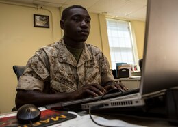 U.S. Marine Corps Pfc. Linard Addison Jr., an administrative specialist assigned to the 26th Marine Expeditionary Unit (MEU) and Marion, S.C., native, checks to ensure the morning accountability report is correct during the work day at the MEU command post aboard  Camp Lejeune, N.C., May 22, 2014. Administrative specialists are mission essential to the MEU through their provision of documentation, processing, and general information for the unit and Marines assigned to the unit to ensure readiness and enable success in operations. (U.S. Marine Corps photo by Lance Cpl. Joshua W. Brown/Released)