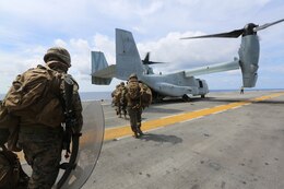 USS PELELIU, at sea – U.S. Marines load onto an MV-22B Osprey during Amphibious Landing Exercise 2015 on the USS Peleliu (LHA-5) as part of a simulated embassy reinforcement, Oct. 2, 2014. PHIBLEX 15 is an annual, bilateral training exercise conducted by the Armed Forces of the Philippines alongside U.S. Marine and Navy forces to strengthen interoperability across a range of military operations to include disaster relief and contingency operations. The Marines are with Co. K, Battalion Landing Team 3rd Battalion, 5th Marines, 31st Marine Expeditionary Unit. The pilots and crew are from Marine Medium Tiltrotor Squadron 262 (Reinforced), 31st MEU. (U.S. Marine Corps photo by Lance Cpl. Richard Currier)
