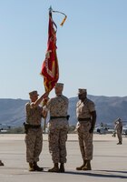 Lt. Col. John Field, right, outgoing commanding officer of Marine Medium Helicopter Squadron (HMM) 364, relinquishes command to Lt. Col. Paul B. Kopacz, left, oncoming commanding officer, during a change of command and redesignation ceremony aboard Marine Corps Air Station Camp Pendleton, Calif., Oct. 9. During the ceremony, HMM-364 was re-designated to Marine Medium Tiltrotor Squadron (VMM) 364.