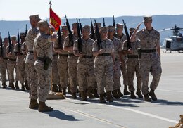 A platoon of Marines salute the outgoing and oncoming commanding officers of Marine Medium Helicopter Squadron (HMM) 364 during a final pass and review at a change of command and redesignation ceremony aboard Marine Corps Air Station Camp Pendleton, Calif., Oct. 9. This is tradition for a change of command ceremony.