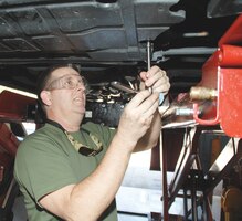 David Balla, supply systems analyst, Logistics Capabilities Center, Marine Corps Logistics Command, and retired Marine, takes advantage of the Auto Skills Center as he performs routine maintenance on his vehicle, Aug. 28. 