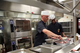 Cpl. Zachery Schern, left, and Lance Cpl. Brandon Ross prepare meals inside the newly renovated mess hall at Marine Corps Air Station Cherry Point, N.C., Sept. 3, 2014. The mess hall recently underwent major renovations to modernize the eating facility for Marines and Sailors at Cherry Point. Schern and Ross are both food service specialists assigned to Headquarters and Headquarters Squadron here.