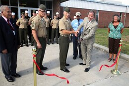 Col. Chris Pappas III cuts the ribbon for the official reopening ceremony of the mess hall at Marine Corps Air Station Cherry Point, N.C., Sept. 5, 2014. Pappas is the Cherry Point commanding officer.