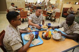 Cpl. Alex D. Tiburciocaceres, left, Pfc. Ulysses Jara, middle, and Lance Cpl. Ebrima Sambou enjoy a meal at the newly renovated mess hall at Marine Corps Air Station Cherry Point, N.C., Sept. 9, 2014. The mess hall opened Sept. 1 after a year-long renovation. Tiburciocaceres, Jara and Sambou are all administrative specialist with Headquarters and Headquarters Squadron here.