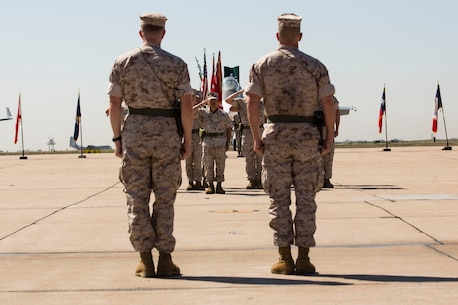 Col. Jason Woodworth, left, commanding officer of Marine Corps Air Station Miramar, California, and Col. John Farnam, former commanding officer of MCAS Miramar, recieve salutes from the staff during a change of command ceremony aboard the air station, Aug. 28. The change of command also marks the end of Farnam's approximately 25 years of active service in the Marine Corps.