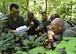 Members of the 709th and 9th Airlift Squadrons use a map to radio in their location to friendly rescue personnel during a combat survival training exercise July 16, 2015, at the Blackbird State Forest near Smyrna, Del. The aircrew evaded enemy forces for several miles before rendezvousing with friendly rescue forces. (U.S. Air Force photo/Airman 1st Class William Johnson)