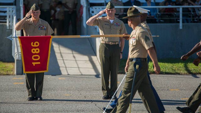 Gen. Robert Neller, commandant of the Marine Corps, saltues during the pass and review at the graduation of America's newest Marines at Marine Corps Recruit Depot Parris Island, S.C., Oct. 16, 2015. The graduates are centennial Marines, because they graduated during the centennial celebration of the depot.
