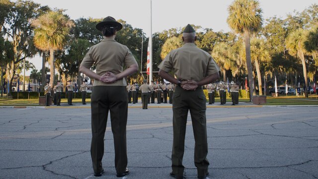 Sgt. Maj. Angela Maness, left, and Brig. Gen. Terry Williams, right, the sergeant major and commanding general of Marine Corps Recruit Depot Parris Island, S.C. stand at parade rest during a morning colors ceremony at the depot, Oct. 16, 2015. Gen. Robert Neller, commandant of the Marine Corps, and Sgt. Maj. Ronald Green, sergeant major of the Marine Corps, also attended the ceremony. 