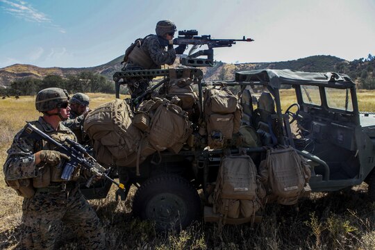 Marines with Company B, 1st Battalion, 1st Marine Regiment, 1st Marine Division, hold security during a patrol at Fort Hunter Liggett, Calif., Sept. 2, 2015. The patrol was part of an experimental exercise designed to assist the Marine Corps warfighting Lab in capturing useful information in order for them to design a newer, more effective vehicle in the future.